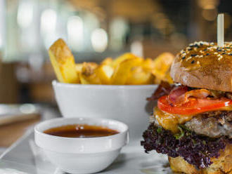 Hovädzí burger v domácej žemli so steakovými hranolkami v bistre na jednotku