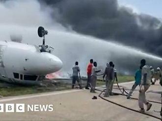 Somalia plane crash: Firefighters tackle blaze by flipped-over plane