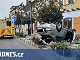 Řidička vyjela ze silnice a trefila strom, dům i chodkyni, auto zůstalo na střeše